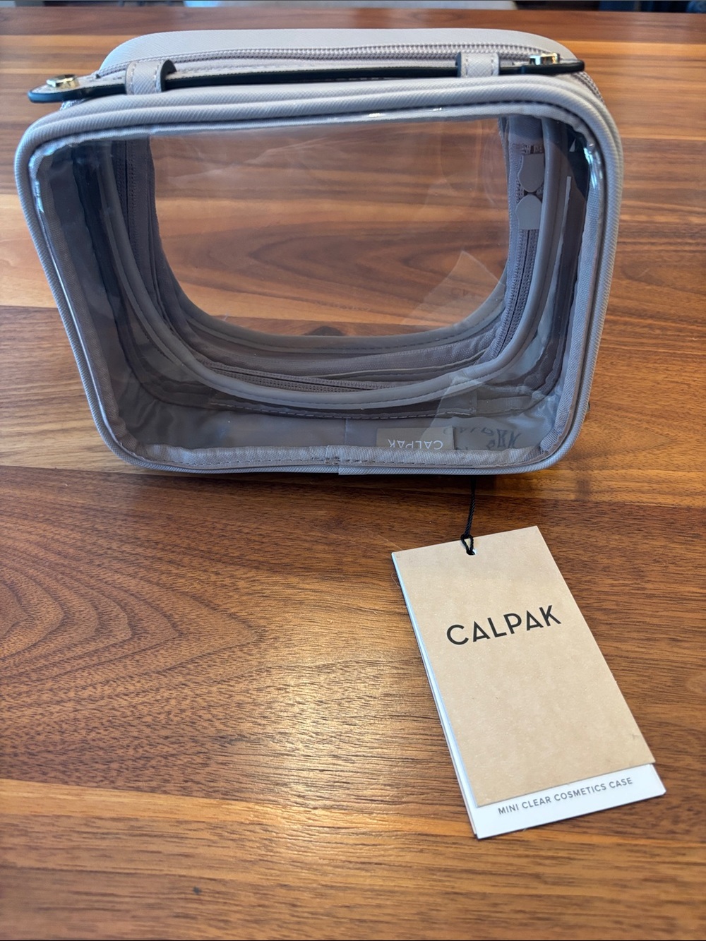 NWT New Calpak Beige Clear Travel Cosmetic Case